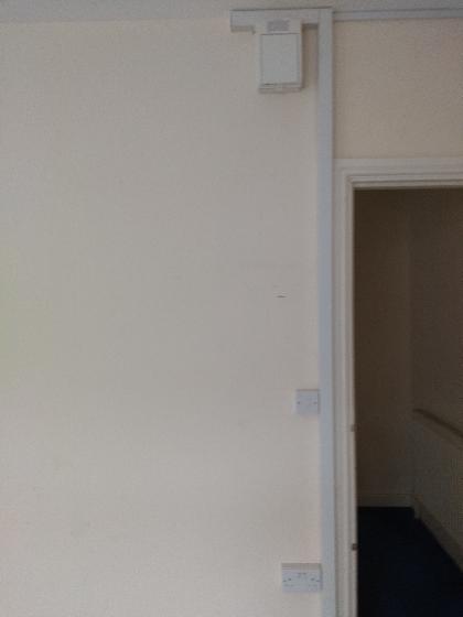 Another individual consumer unit, light switch and one of the sockets installed in trunking.