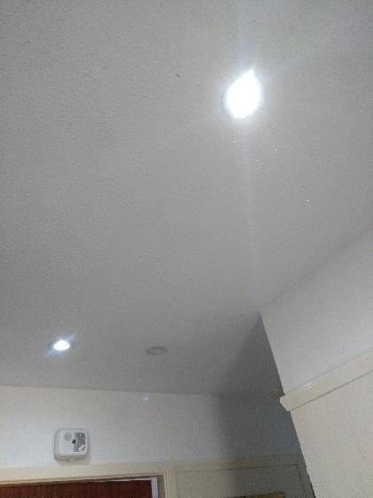 First image of a single light removed from L shaped hall way and replaced with 3 LED downlight's.